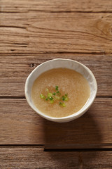 bowl of broth soup on wooden table. 