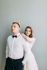 Stylish wedding in European style. Beautiful couple celebrating and drinking champagne in the Studio.