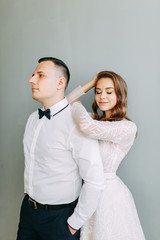 Stylish wedding in European style. Beautiful couple celebrating and drinking champagne in the Studio.