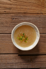 bowl of broth soup on wooden table. 