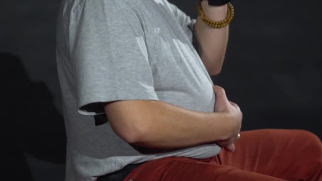 Young guy with a stomach on a gymnastic ball.