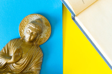 Buddha figurine and open book