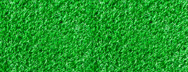 textural grassy green background made from grass of a football field.