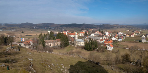 Fototapeta na wymiar Ruins of the castle Sokolac and village Brinje in background, Lika, Croatia