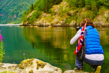 Tourist with camera on fjord, Norway