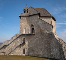Fototapeta na wymiar Ruins of the castle Sokolac with the chapel of Holy trinity on the hill in village Brinje, Lika, Croatia