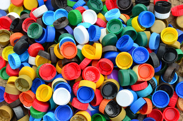 Plastic bottle caps background. Cap material is recyclable.Remove lids from plastic bottles before recycling them. Recycling collection and processing plastic bottle caps