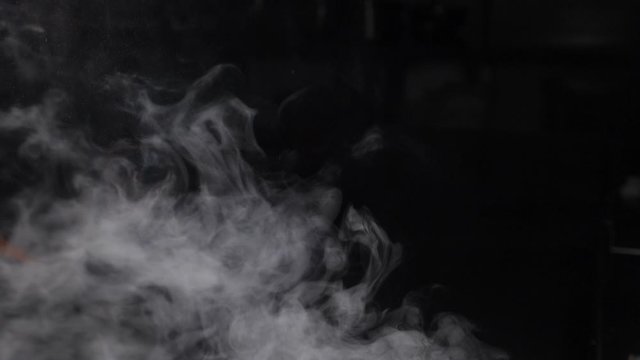 Fire Smoke from Bottom Up on Black Background. White vapor rising up. Dense smoke while cooking. Slow motion. hd