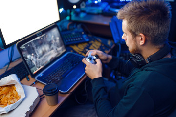Gamer with joystick playing videogame on console