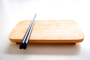 The plates and chopsticks are set on the to put food white table     