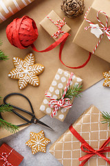 Christmas gift boxes, wrapping paper, cookies and red ribbon.