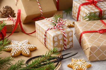 Christmas gift boxes, wrapping paper, cookies and red twine.