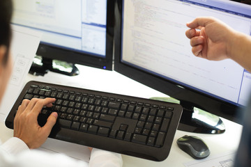 Hand team of programmers are discussing the use of online business investment management software in the future.business concept