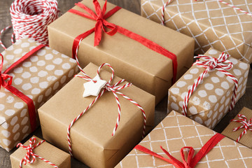 Lots of gift boxes decorated with red ribbon and twine.