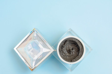 magnetic face mask in a cosmetic jar on blue background