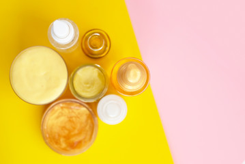 jars with cosmetics on a colorful background top view.  minimalist creative concept. space for text.