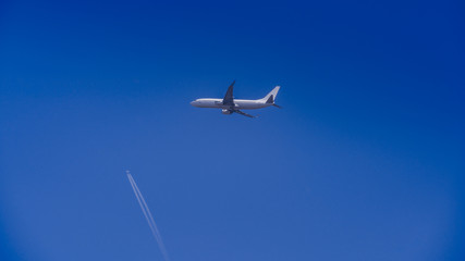 Modern airplane taking off in the blue sky