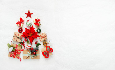 Christmas tree made from Christmas gifts and decorations on white background. Creative winter holiday concept. Flat lay.