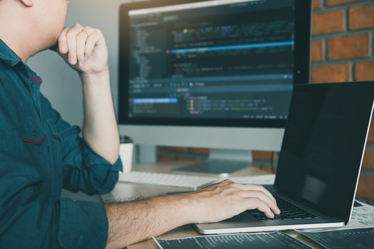 Developing programming and coding technology working in a software develop company office.