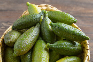 Heap of fresh raw green finger limes