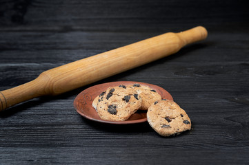 cookies on a black background with a clay plate