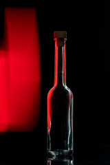 empty glass bottle on a black background