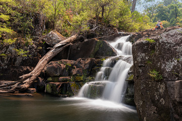 hiker resting on top of gloucester falls with low flow water due to drought