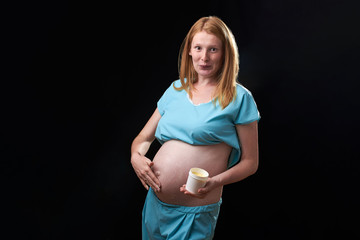 happy pregnant woman with belly cream. prevention of stretch marks. Pregnancy and skin care. belly of pregnant woman and smile from moisturizing cream for stretch marks