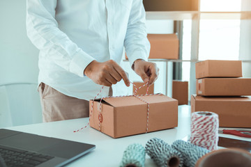 Young asian teenage product owners are packing small business packaging products in boxes prepared...