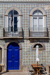House front decorated with azulejos in Tavira, Algarve, Portugal.