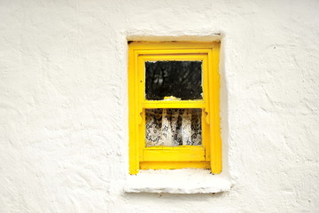 Stone house with wooden window frames