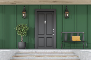 Black front door of green house, tree and bench