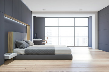 Side view of gray bedroom with home office