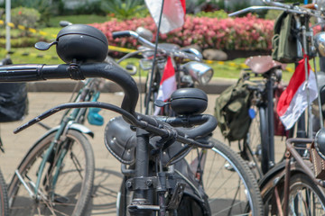 Fototapeta na wymiar Selective Focus handlebar Retro styled of a nineteenth century bicycle on indonesian city