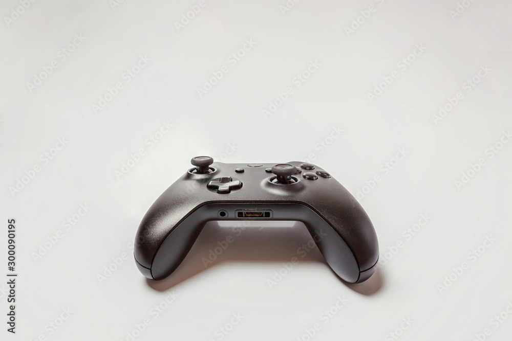 Wall mural black joystick gamepad, game console isolated on white background. computer gaming technology play c