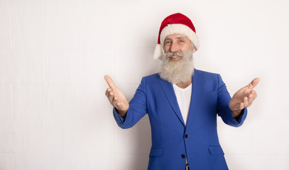 Fototapeta na wymiar Holly jolly xmas, new year is soon! Be ready, prepare. Sales, discounts, presents, gifts selling time. Man wearing blue suit and red hat.