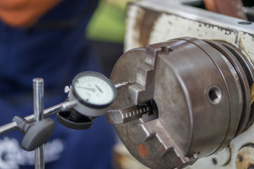 the device for measuring the end runout. Concept micrometer with measuring scale and indicator, lathe, profession Turner, equipment, beat check.