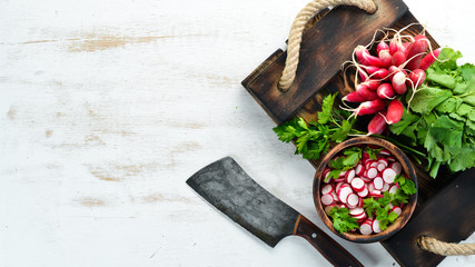 Sliced radishes on a Wooden Table. Fresh vegetables. Top view. Free space for text.