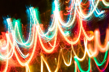 Close-up abstract  luminous background of blurred glowing diagonal neon waves on dark.