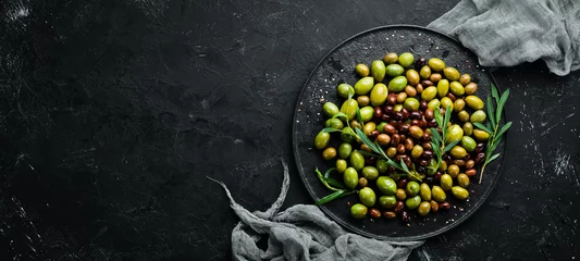 Poster Olives in a bowl, olive oil, spices and herbs. Top view. Free space for your text. © Yaruniv-Studio