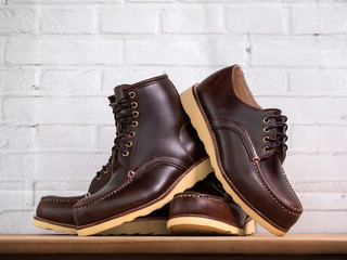 Men fashion set of brown shoes on white brick background.