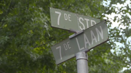 Street name sign against trees in city - Johannesburg, South Africa