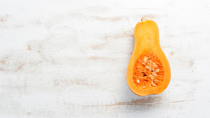 Fresh pumpkin on white wooden background. Healthy food. Top view. Free copy space.
