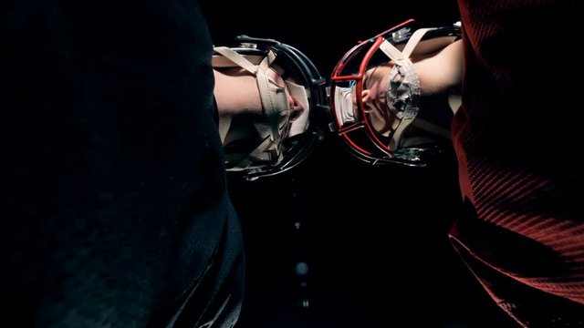 Footballers bumping their heads, bottom view.