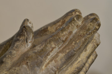 A detail of a statue of praying hands in a Cornish Church