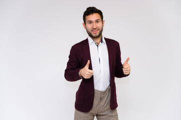 Men's fashion concept. Portrait of a handsome male model showing hands with a perfect body wearing a dark jacket, posing on a white background. Black hair. Close Studio Shot