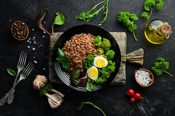 Boiled buckwheat with egg and broccoli. Dishes menu. Free copy space. Top view.