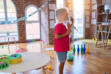 Adorable toddlers playing around lots of toys at kindergarten