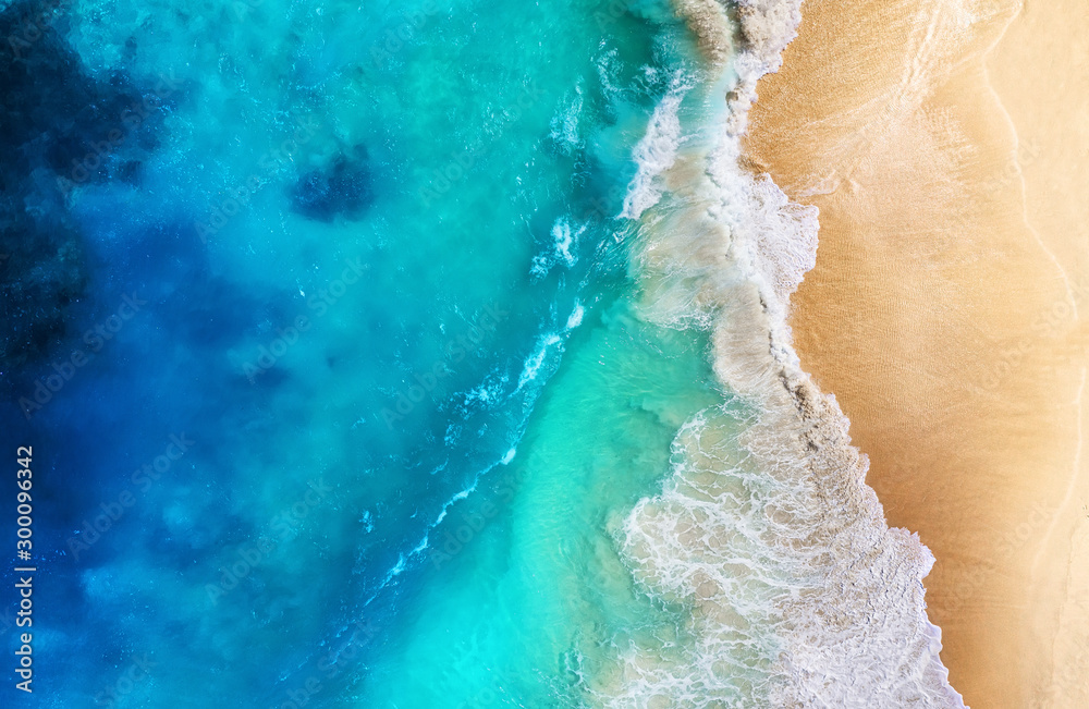Wall mural coast and waves as a background from top view. turquoise water background from top view. summer seas