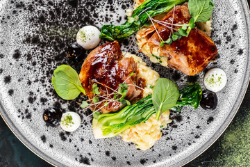 Grilled chicken breast. Fried chicken fillet and fresh vegetable salad of tomatoes, cucumbers and arugula leaves. Chicken meat with salad. Healthy food. Flat lay. Top view. Dark background